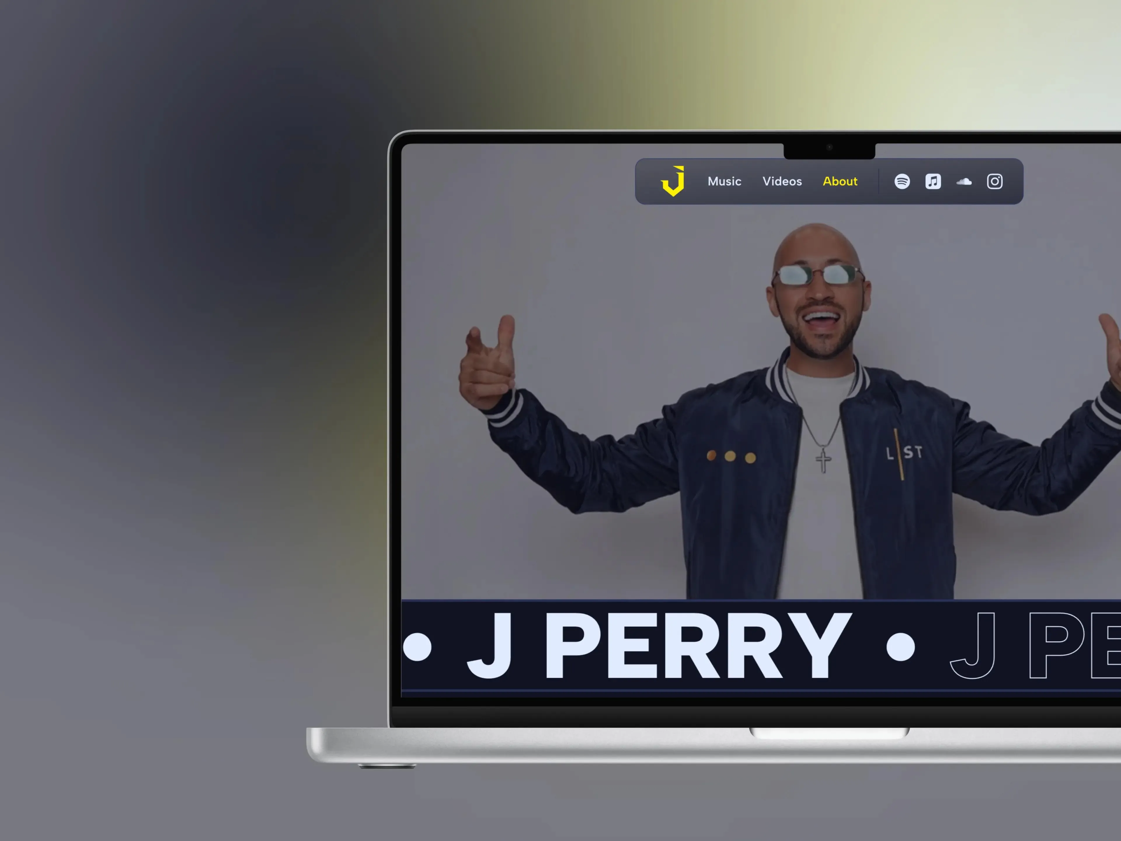The About page on a laptop - J Perry with arms outstretched above a scrolling marquee of his name