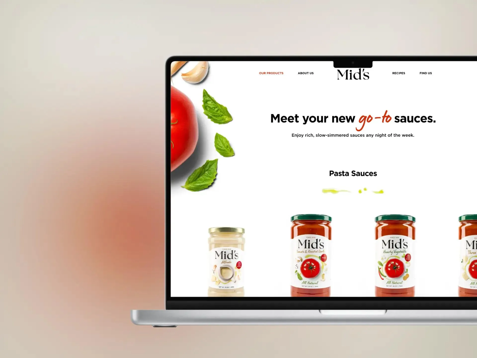 The products page on a laptop - "Meet your new go-to sauces" above the pasta sauce range: Alfredo, Tomato & Roasted Garlic, Hearty Vegetable and Three Cheese